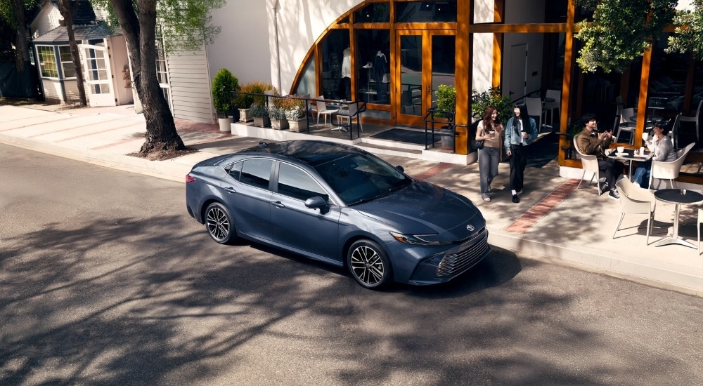 Blue 2026 Toyota Camry XLE for sale near Franklin parked near a restaurant