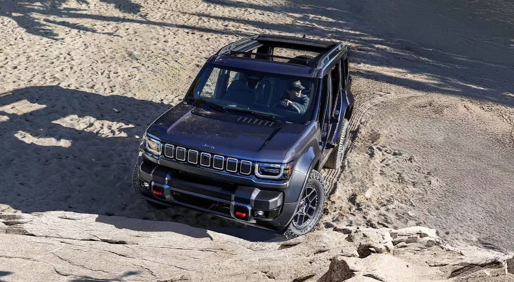 High view of a black 2025 Jeep Recon parked off-road.