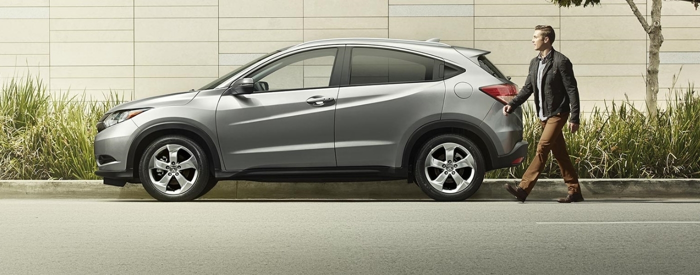 Person approaching a grey 2016 Honda HR-V