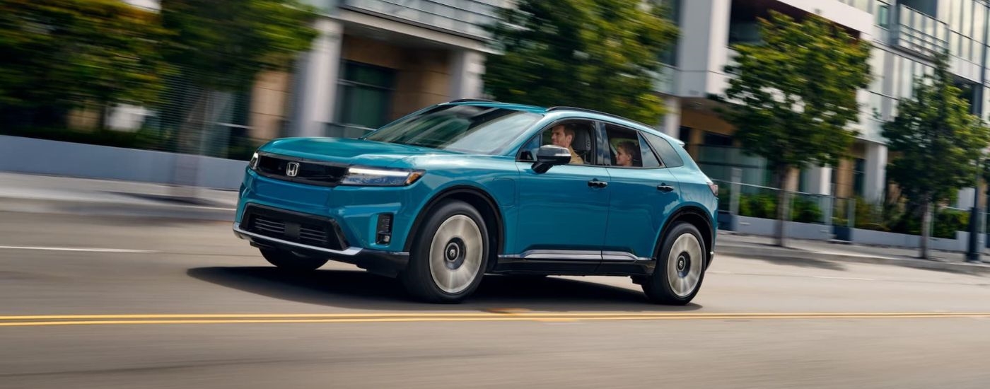 Teal 2024 Honda Prologue Elite driving to look at used SUVs for sale in West New York