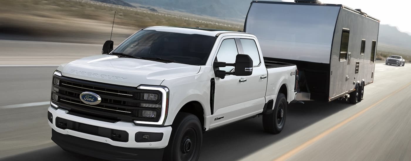 White 2025 Ford F-350 for sale near Greenfield towing a camper van.