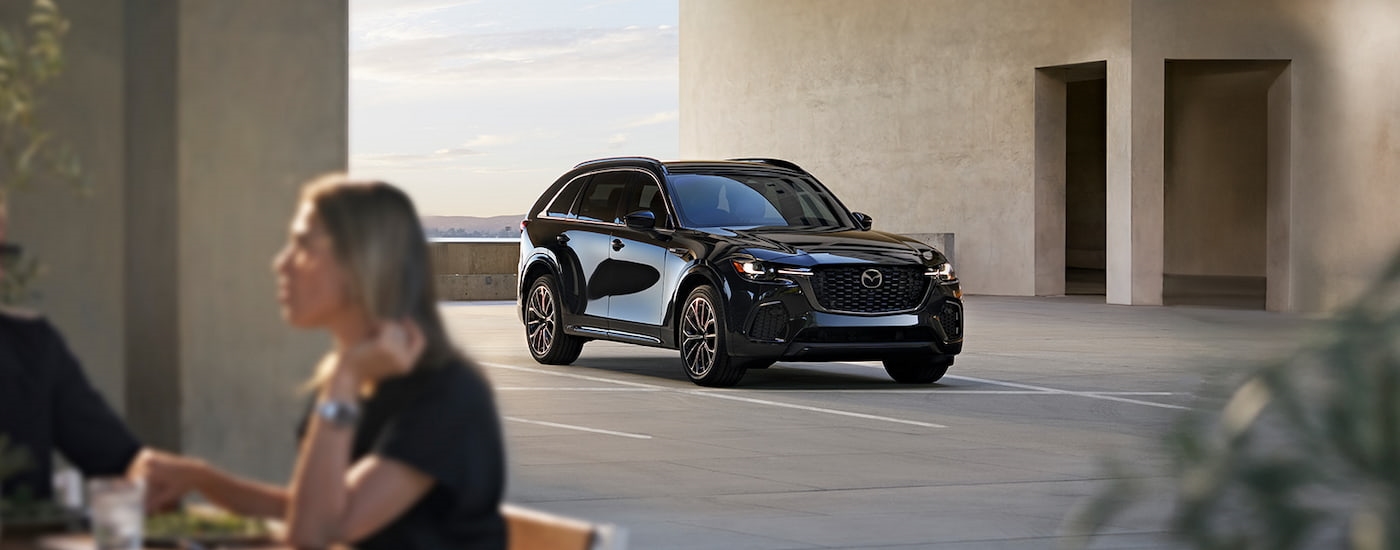 Black 2025 Mazda CX-70 for sale parked on a parking lot.