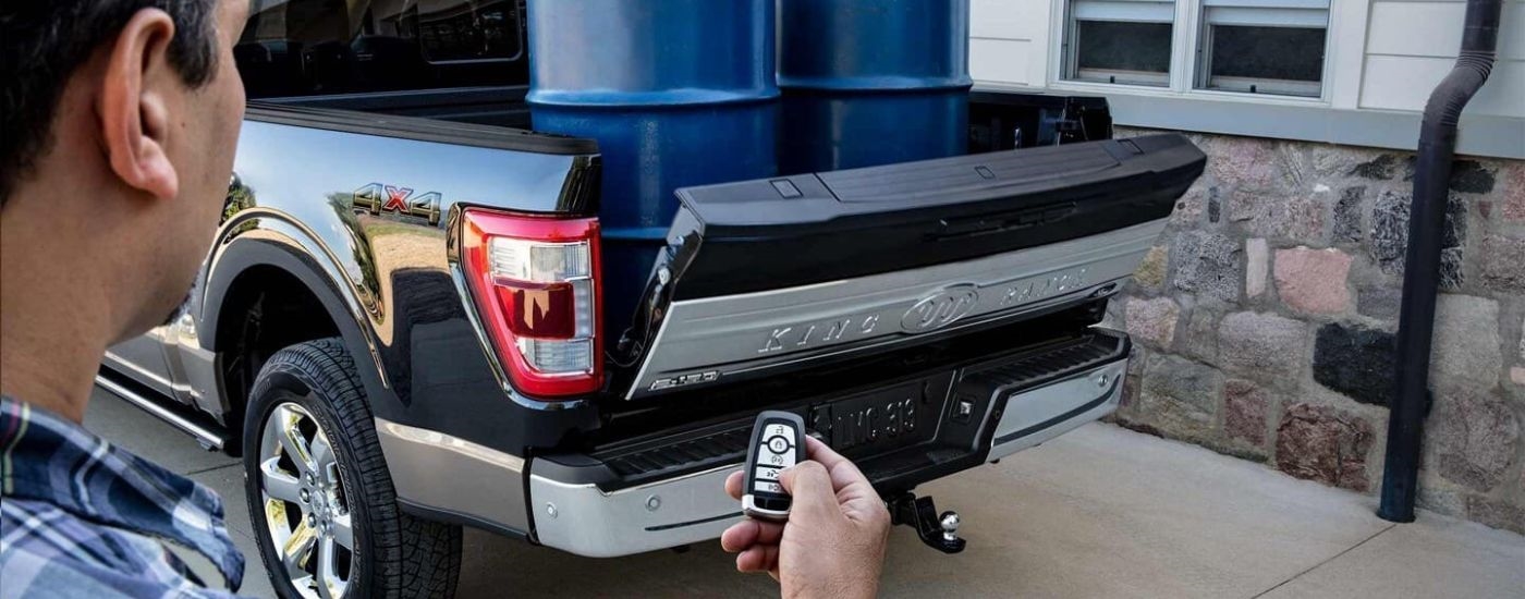 Blue barrels in the bed of a black 202 Ford F-150