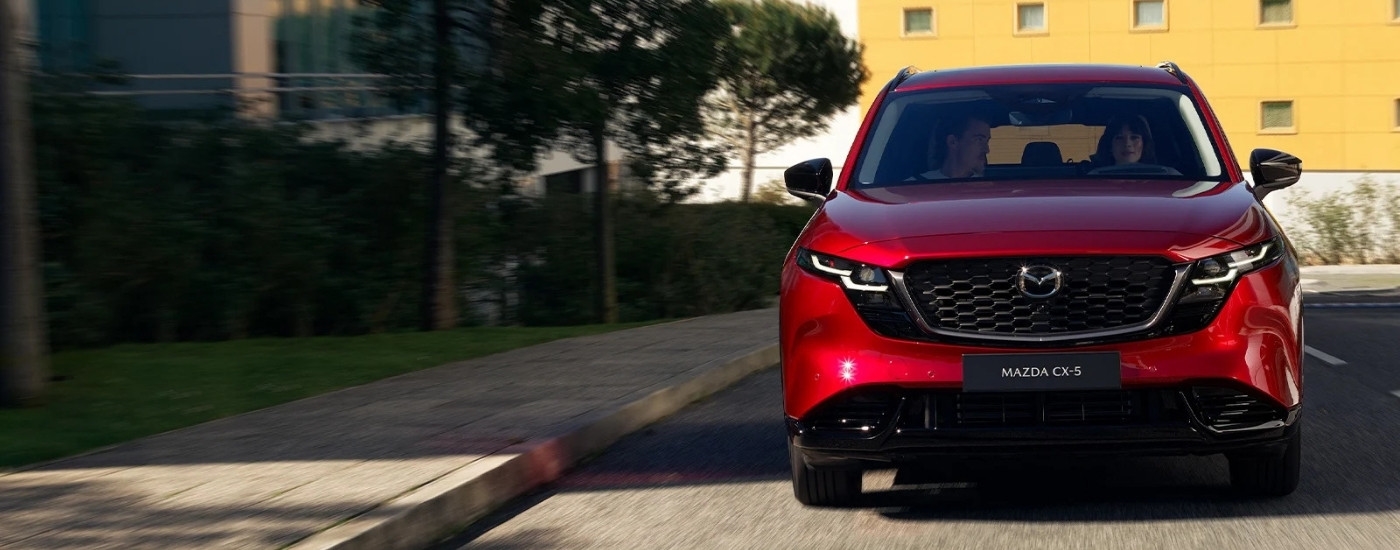 Red 2026 Mazda CX-5 driving on a city street