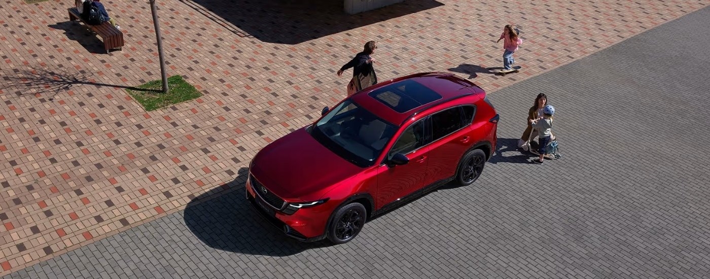 Kids playing near a 2026 Mazda CX-5