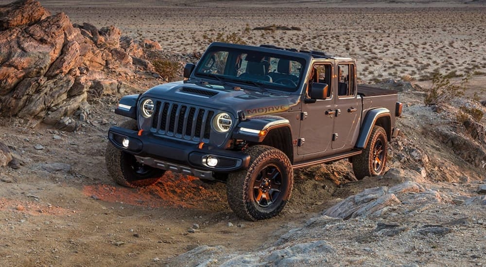 Black 2021 Jeep Gladiator driving off-road.