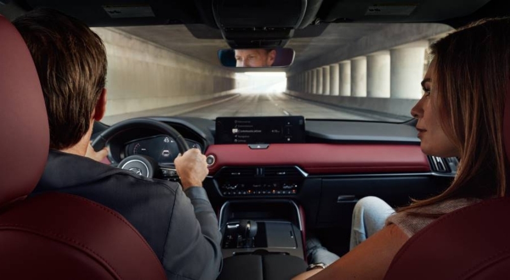 People driving a 2026 Mazda CX-70 through a tunnel