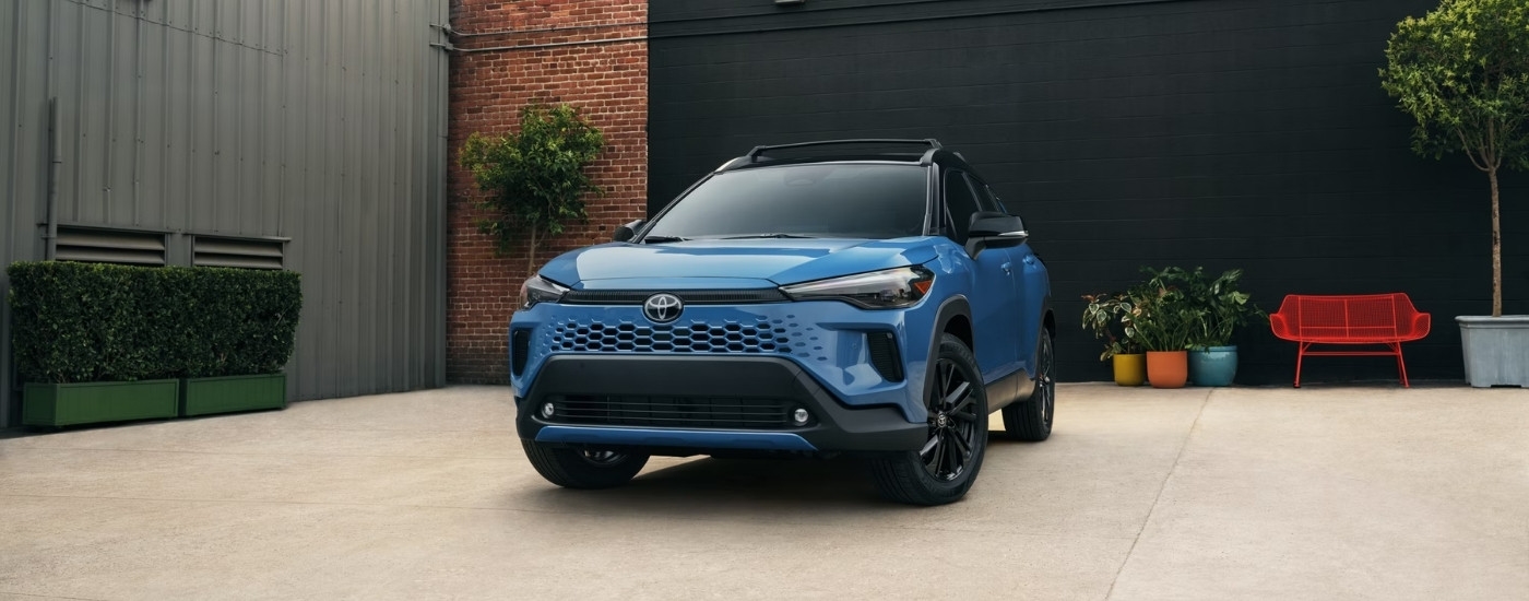 Blue 2026 Toyota Corolla Cross Hybrid XSE parked in a courtyard