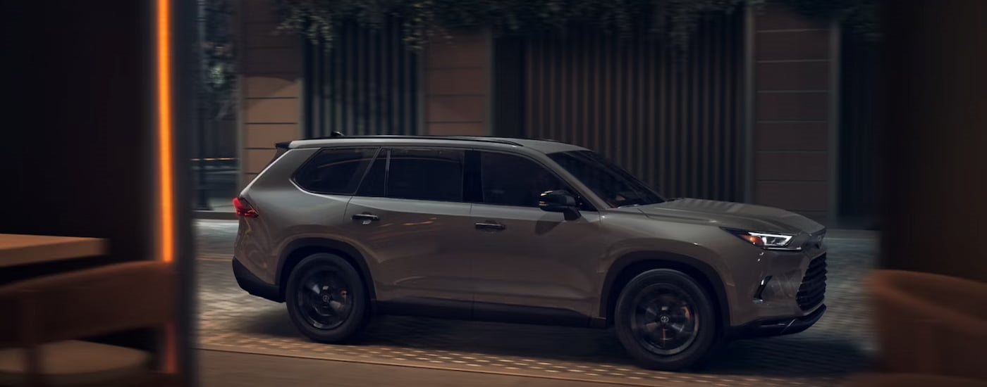 Side of a grey 2026 Toyota Grand Highlander for sale near Mount Vernon parked by a curb.