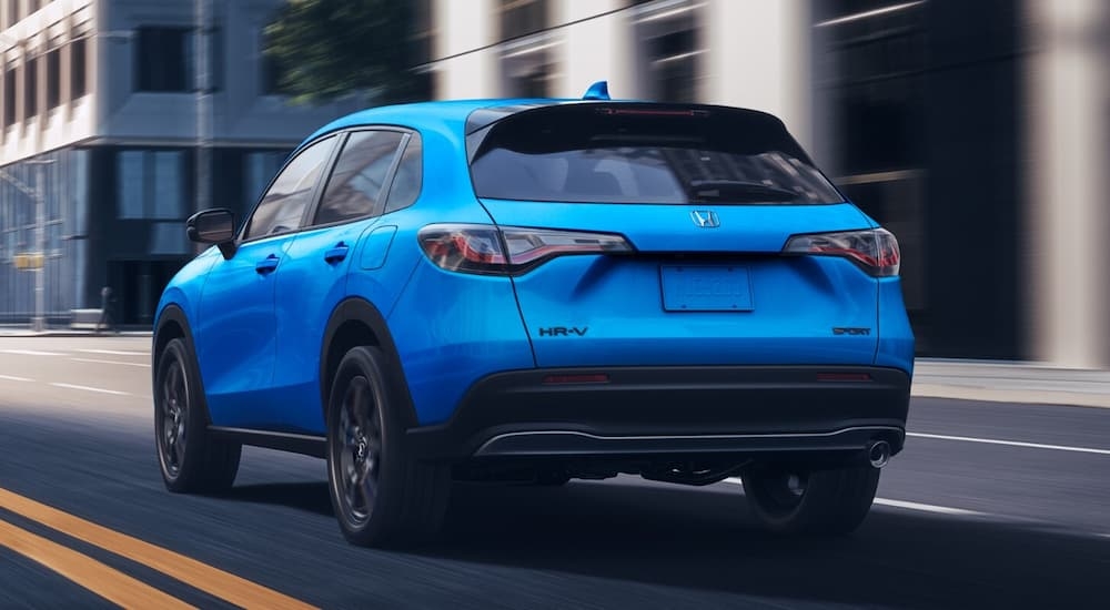 Blue 2026 Honda HR-V driving through a city