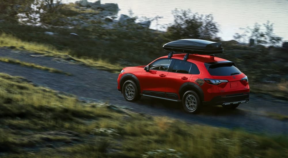 Red 2026 Honda HR-V HPD driving on a gravel road