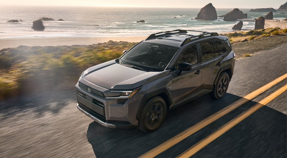 Grey 2026 Toyota RAV4 for sale near Glasgow driving down an open road.