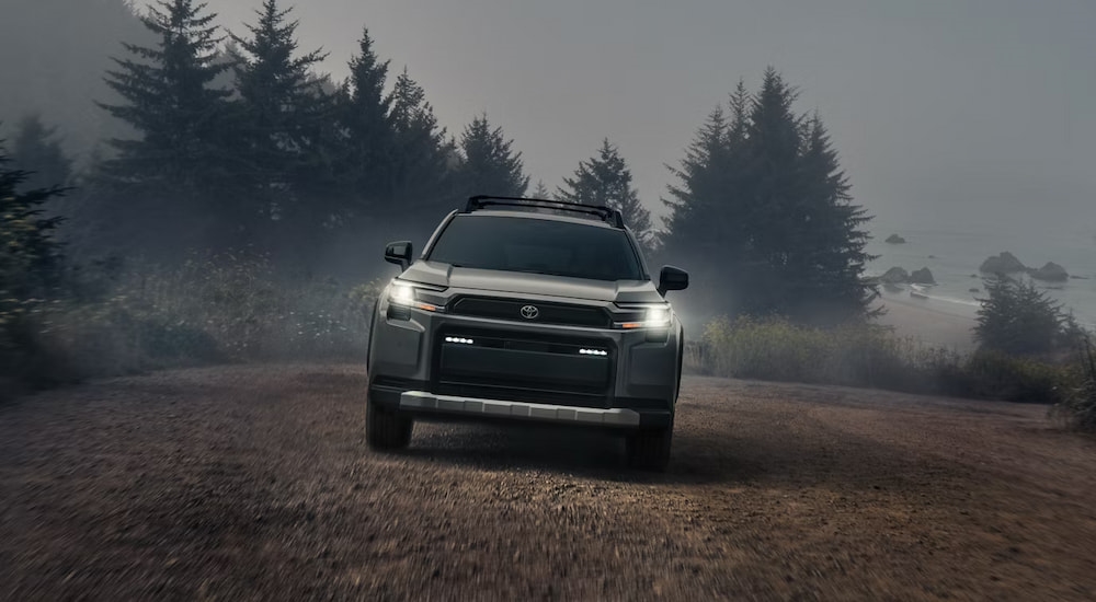 Front of a grey 2026 Toyota RAV4 driving off-road.