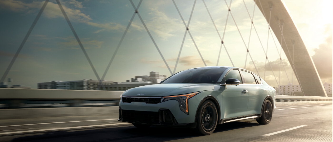 2026 Kia K4 driving on a bridge