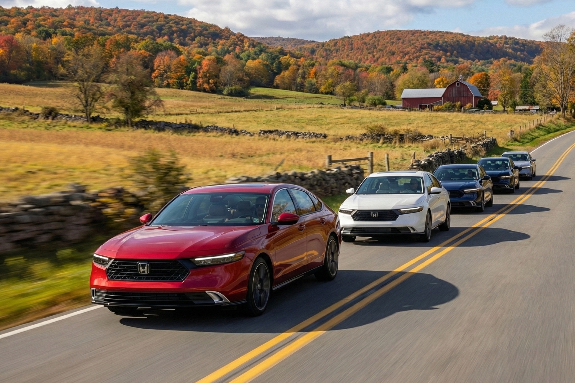 2026 Honda Accord Trim Levels driving down a rural roadway with autumn colors and old barns