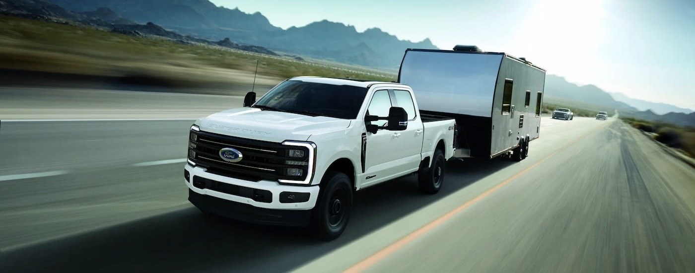 White 2025 Ford F-350 for sale near Greenfield towing a camper van.