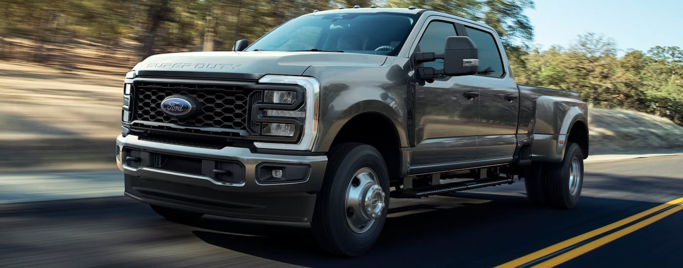 Grey 2026 Ford F-350 for sale in Westminster driving down a road.