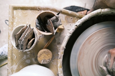 a pottery wheel with tools surrounding it