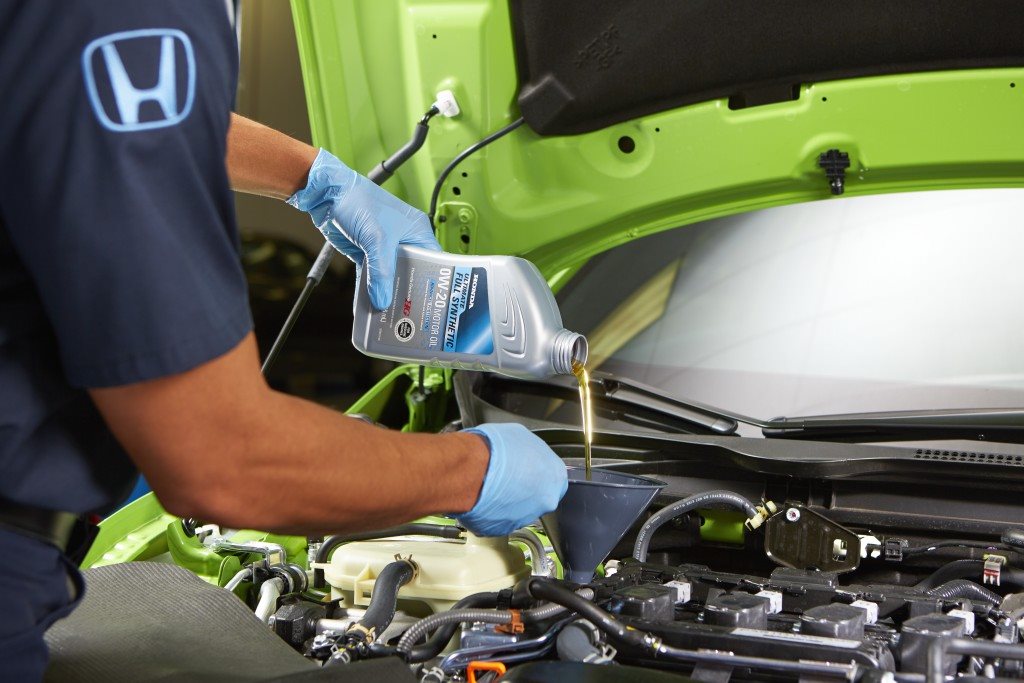Honda technician working under the hood of a Honda