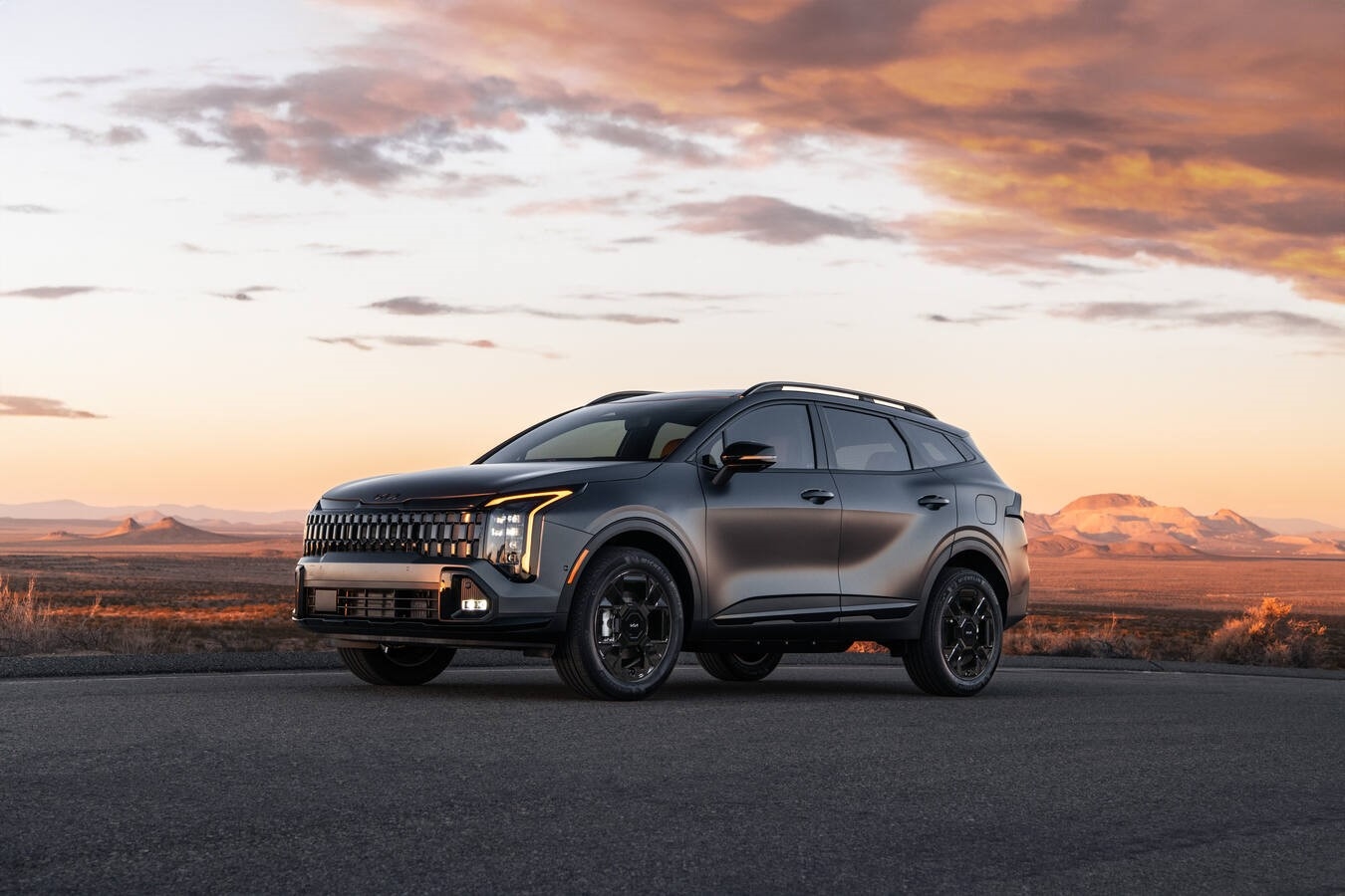 2026 Kia Sportage Plug-In Hybrid driving in Denver near the mountains with AWD capability