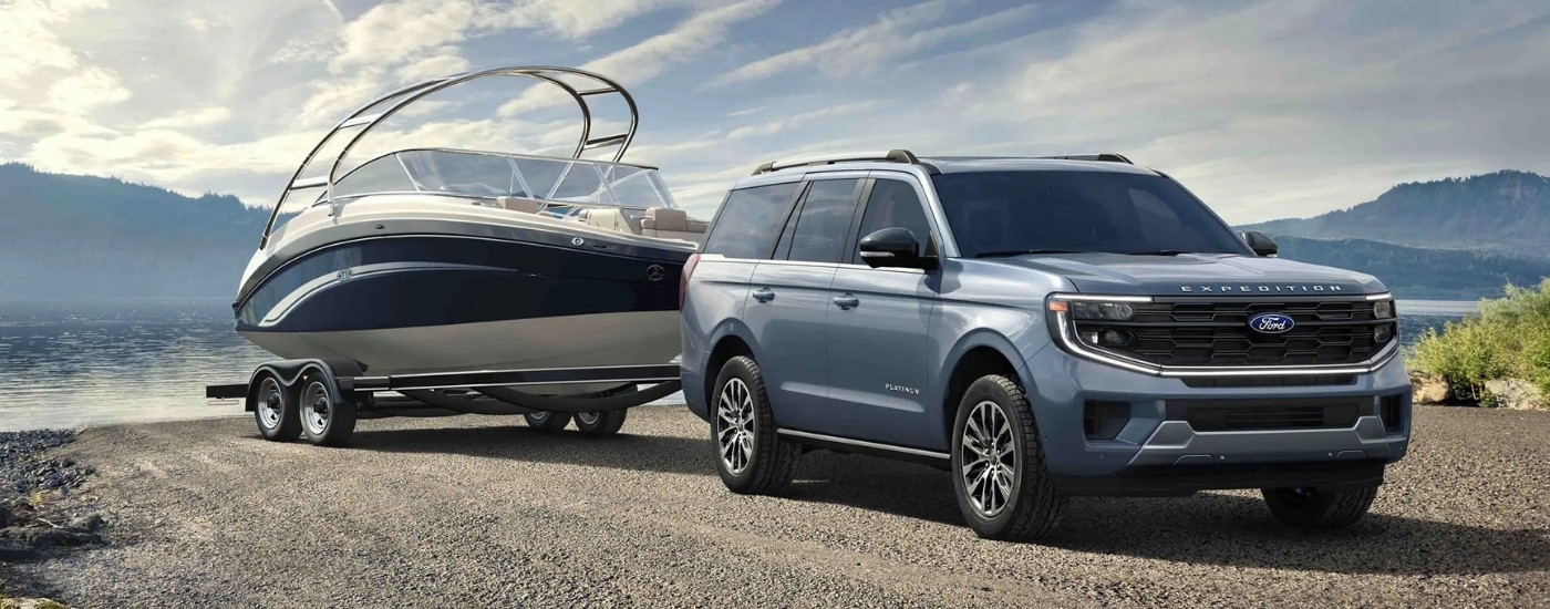 Blue 2025 Ford Expedition Platinum pulling a boat out of a lake