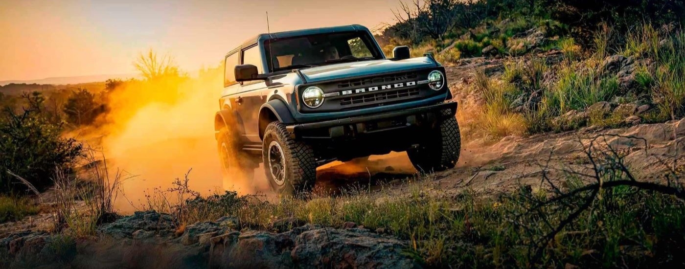 Blue 2022 Ford Explorer driving off-road.