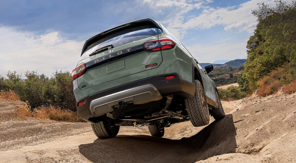 Green 2026 Honda Pilot TrailSport off-roading