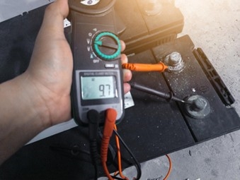 Close-up of car battery voltage check