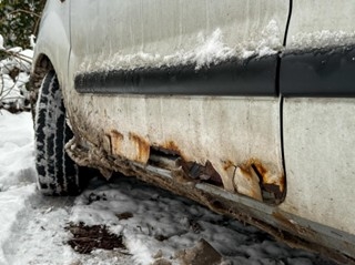 Rust beginning to form on vehicle undercarriage from winter salt exposure