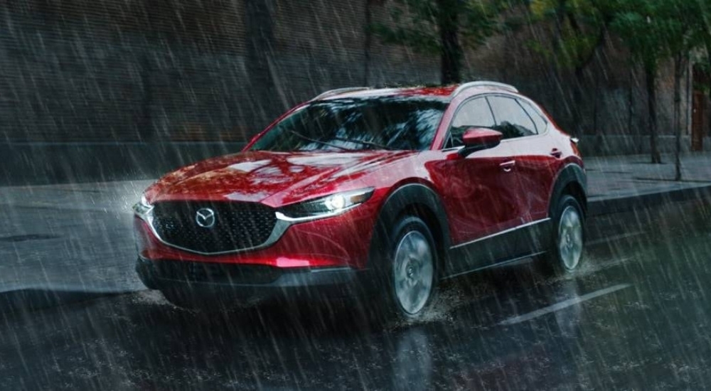 Red 2026 Mazda CX-30 driving through the rain