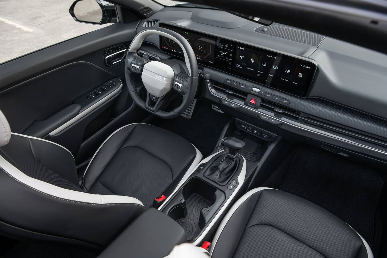 2026 Kia K4 interior cockpit with large digital displays and modern steering wheel controls