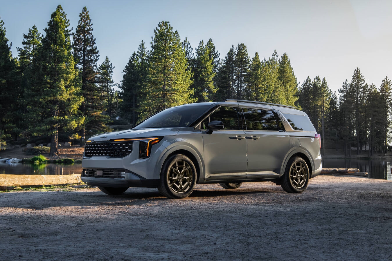 2026 Kia Carnival gas and 2026 Kia Carnival HEV parked in Denver with a family-ready minivan stance