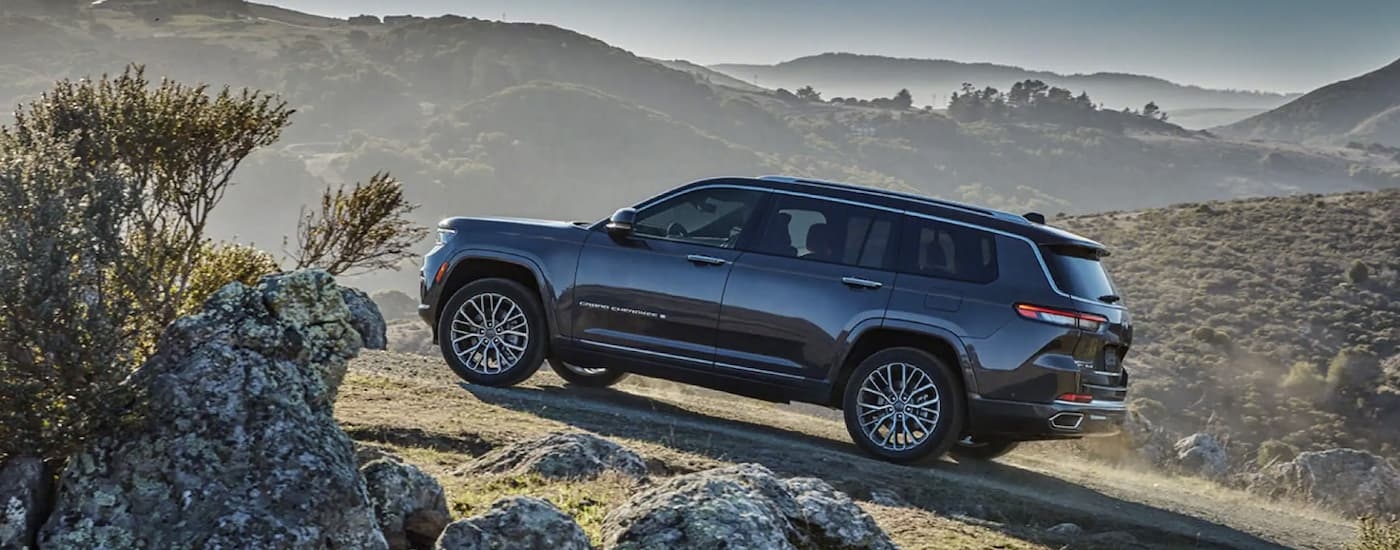 Grey 2022 Jeep Grand Cherokee driving up a hill