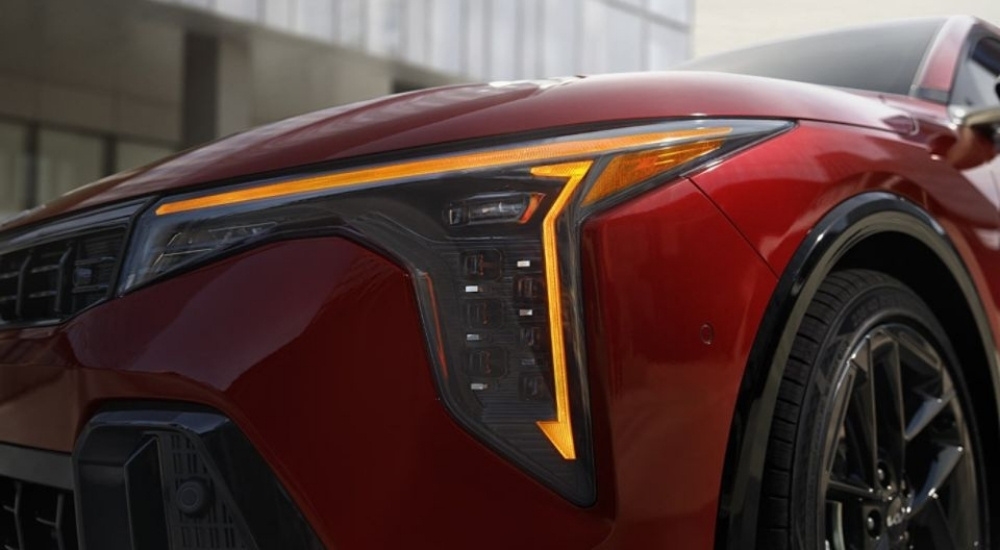 Driver side headlight on a red 2026 Kia K4