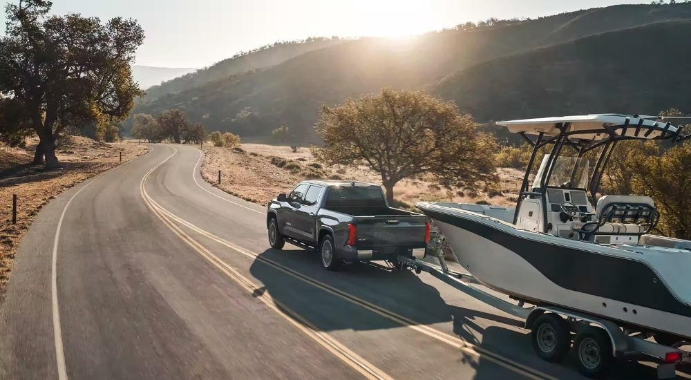 A grey 2026 Toyota Tundra towing a boat