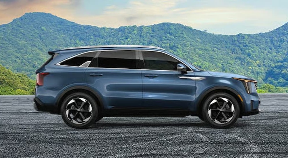 A blue 2026 Kia Sorento S parked off-road.