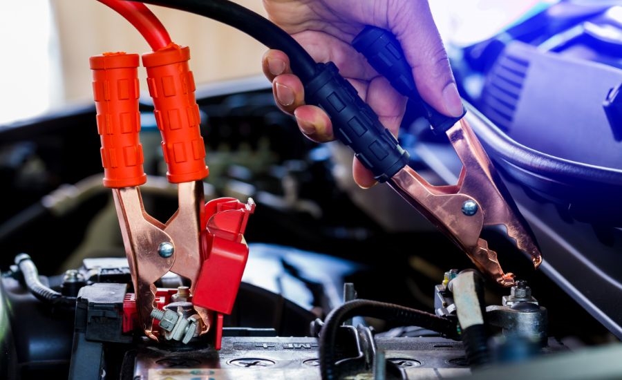 Technician performing a Kia battery inspection using a professional load tester in Denver service bay