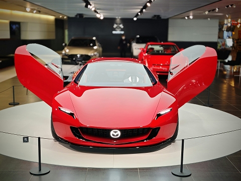 red Mazda concept car in a showroom