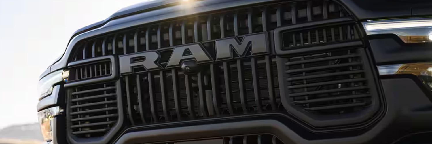 Up close shot of RAM badge on front grille of truck