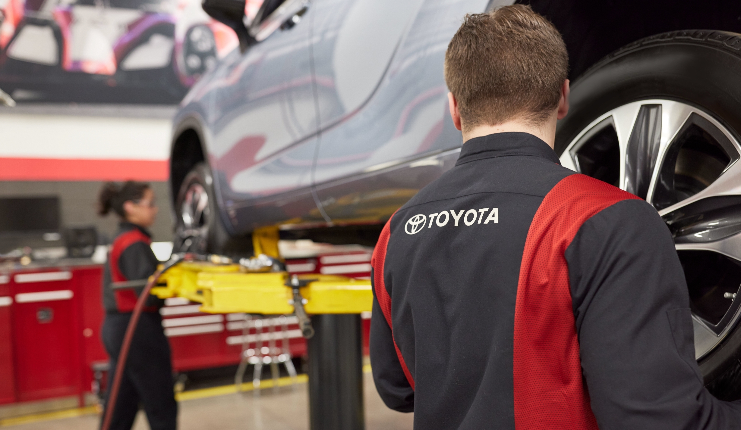 Toyota service technician performing vehicle maintenance at Toyota of Downtown Chicago