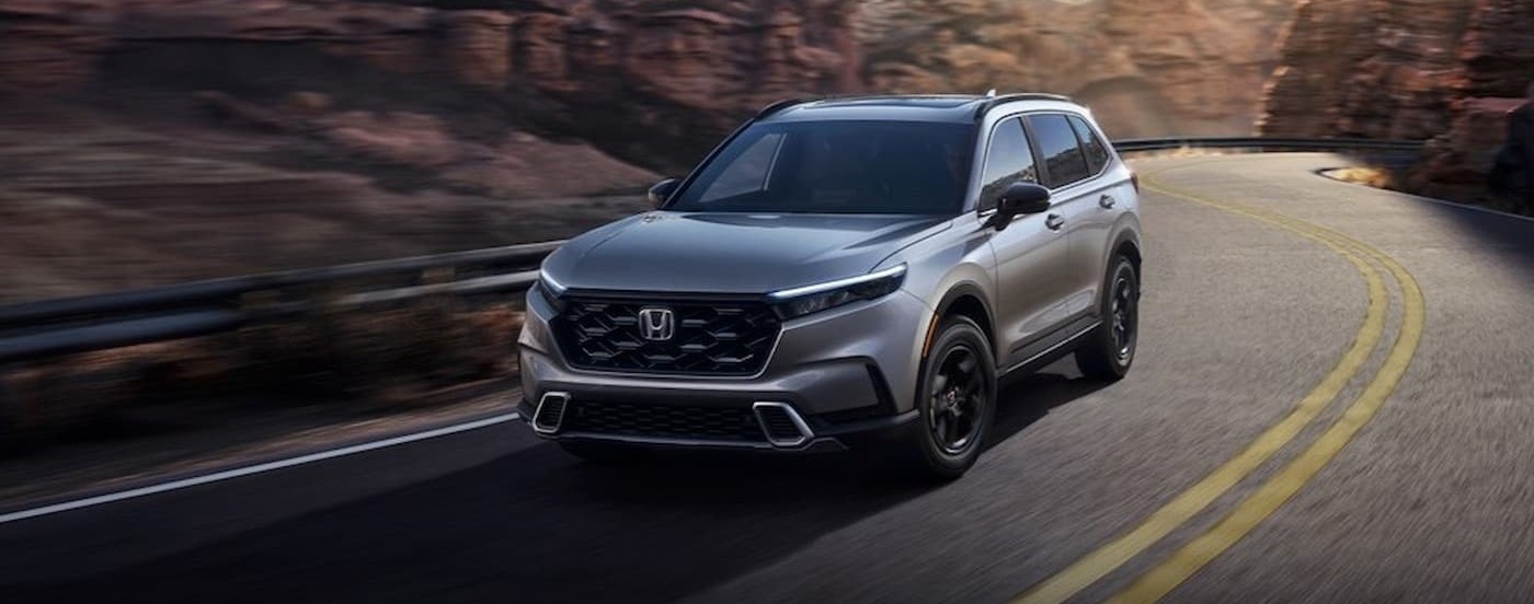 Silver 2023 Honda CR-V driving on a highway.
