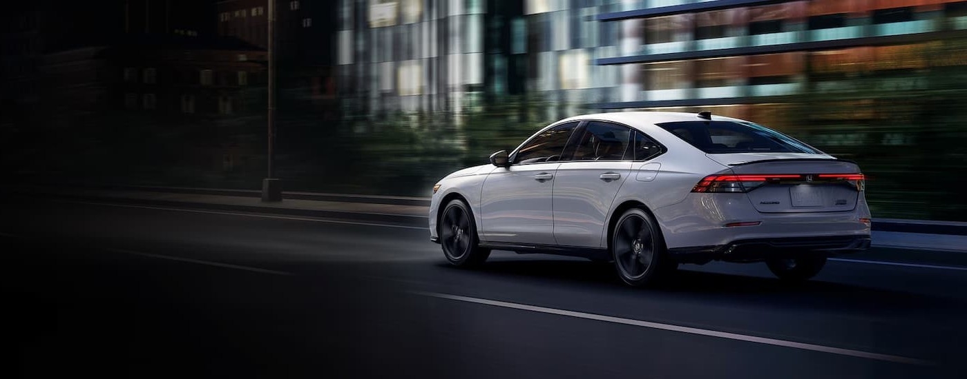A white 2026 Honda Accord driving in a city.