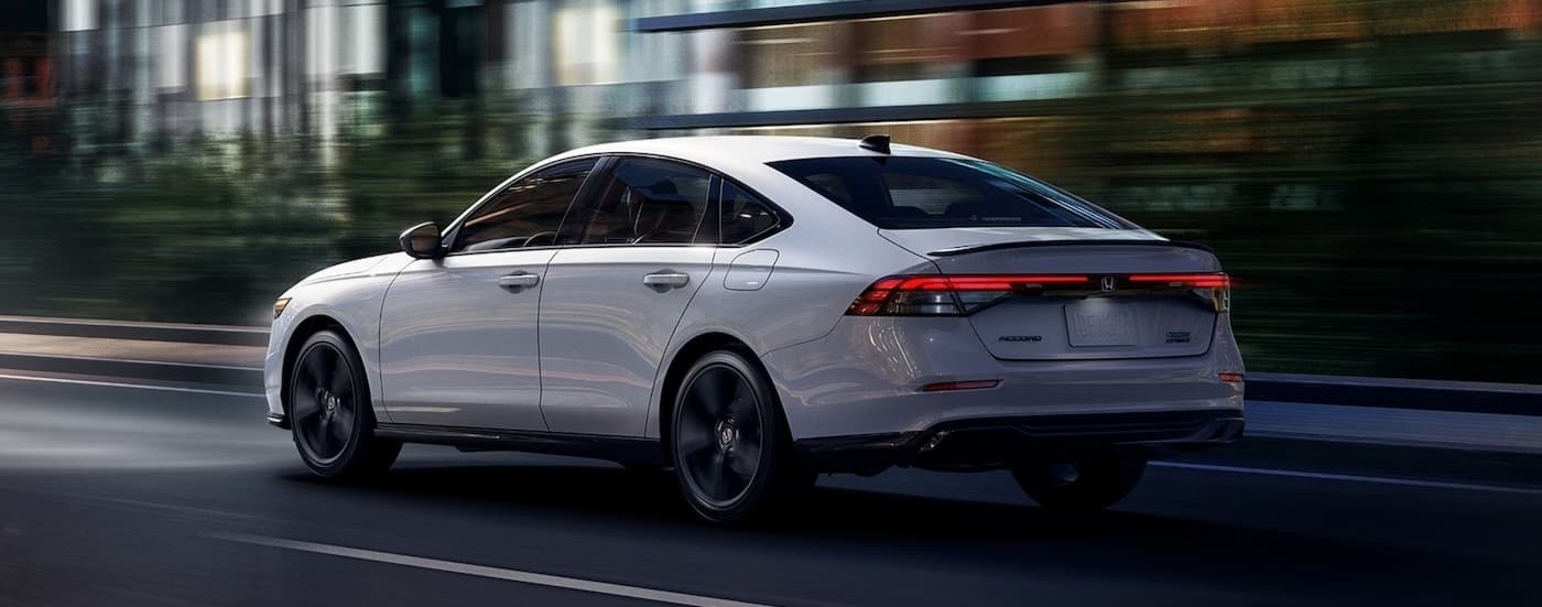 A white 2026 Honda Accord driving in a city.