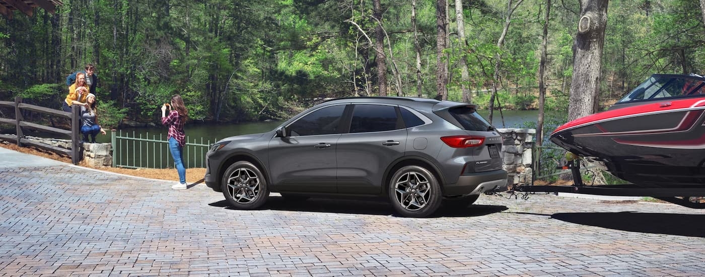 Rear of a grey 2026 Ford Escape parked by a lake.