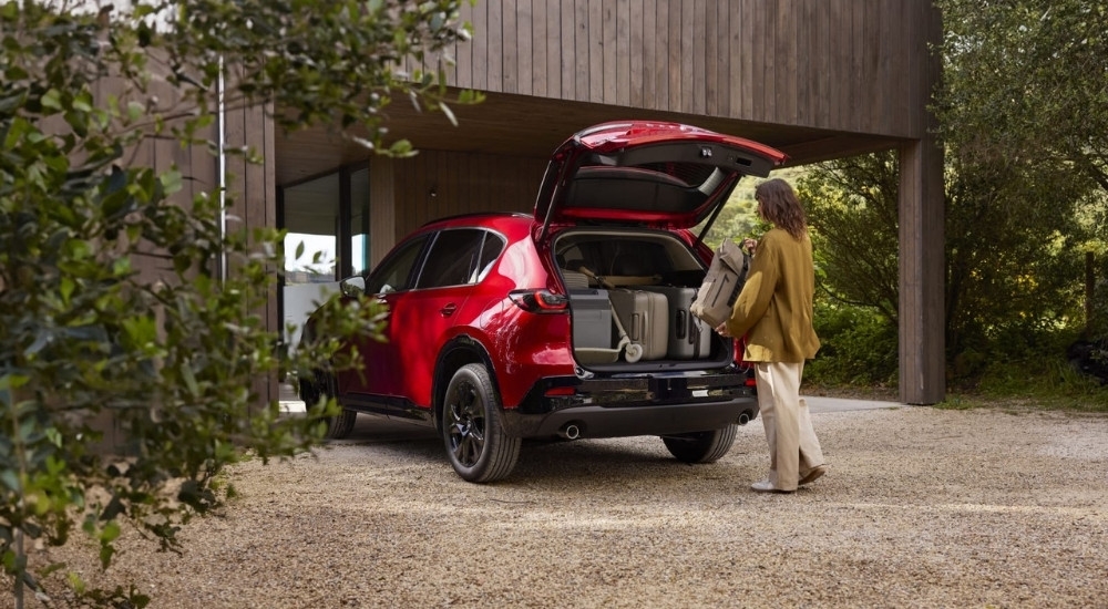 Person loading luggage into a 2026 Mazda CX-5