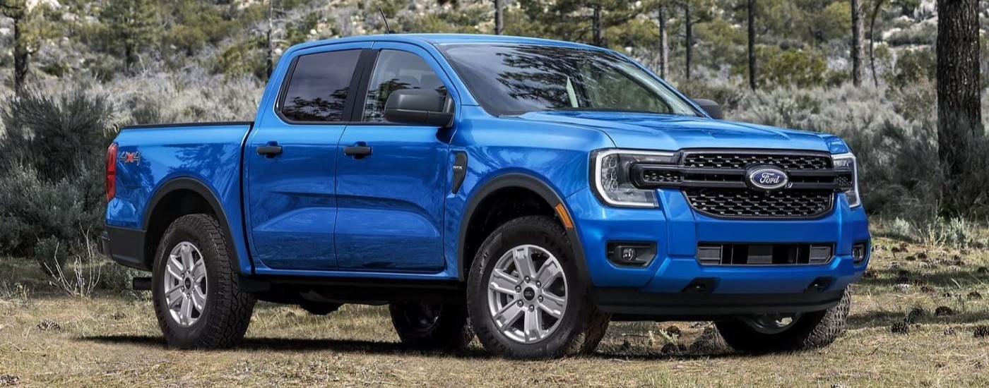 Blue 2026 Ford Ranger STX parked off-road.