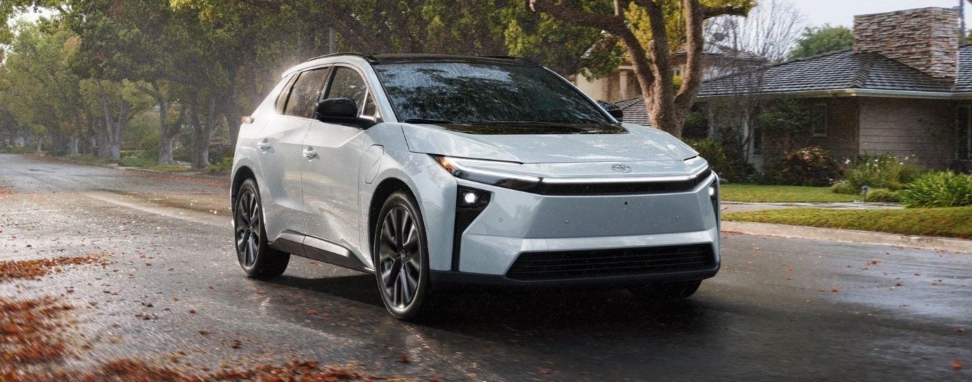 White 2026 Toyota bZ driving on a suburban street