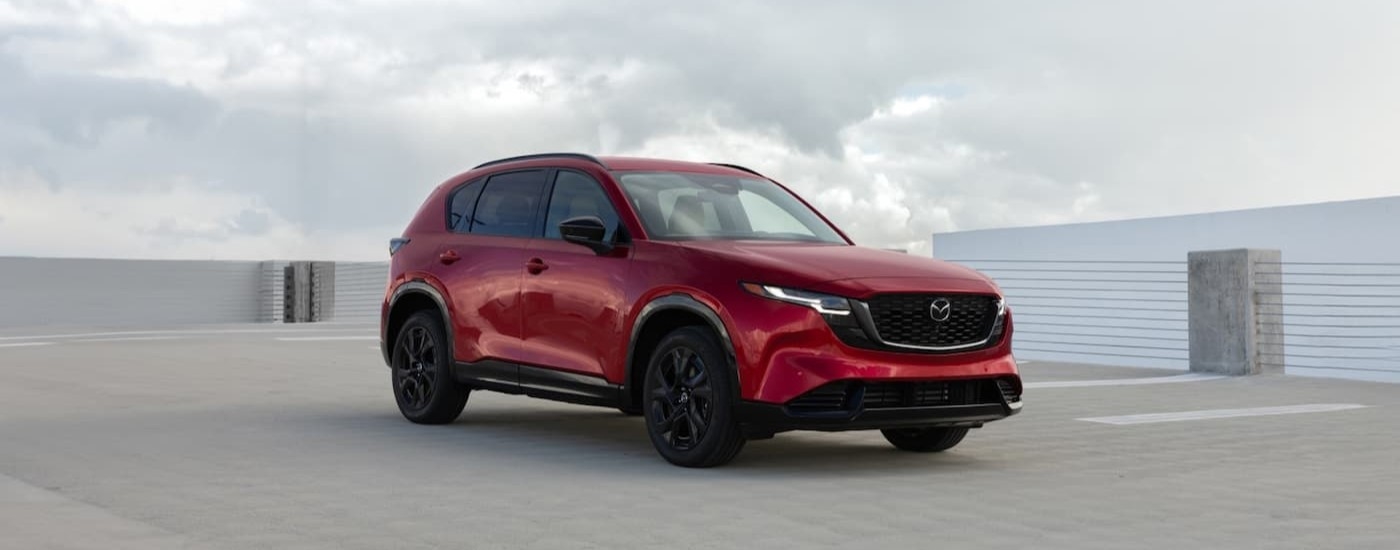A red 2025 Mazda CX-5 parked on a rooftop.