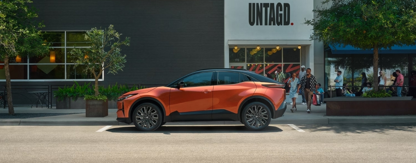 Orange 2026 Toyota C-HR XSE parked in front of a building