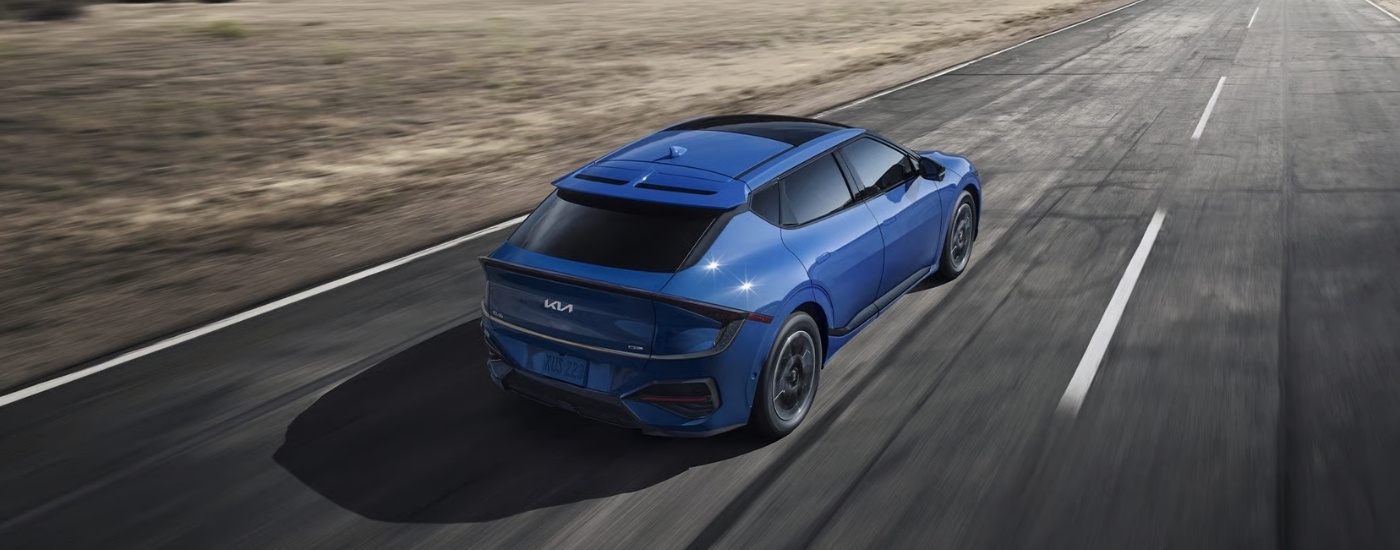 Blue 2025 Kia EV6 GT driving on a highway
